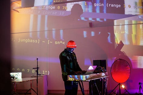 Images of artists working with computers and projectors in an art gallery