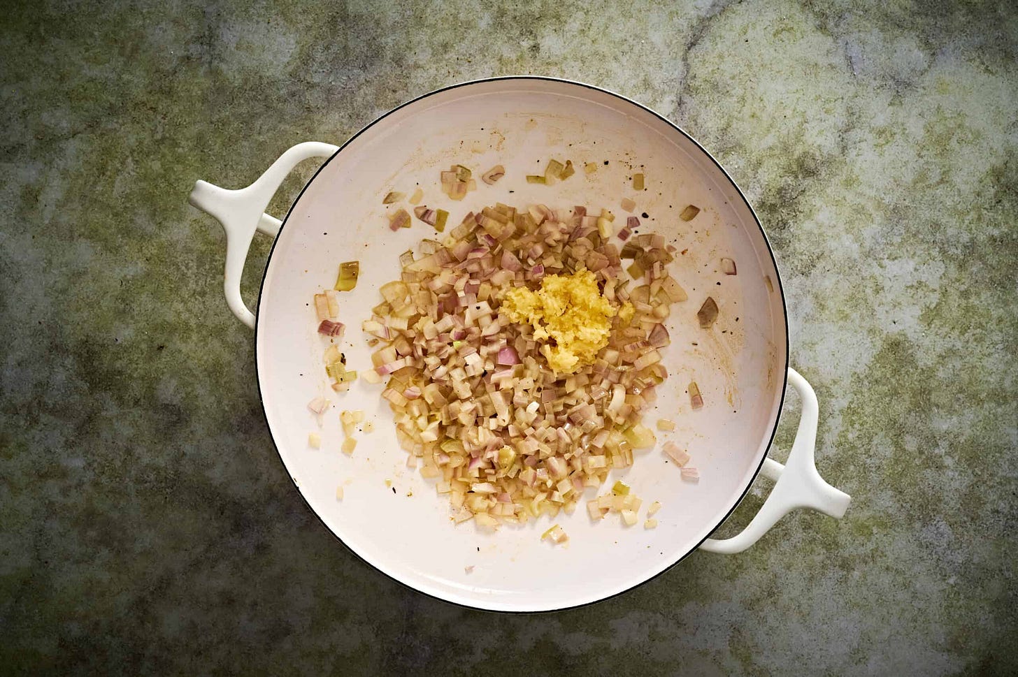Lemon chicken orzo pasta with Sauté Aromatics in the same white pan, and melted butter. 