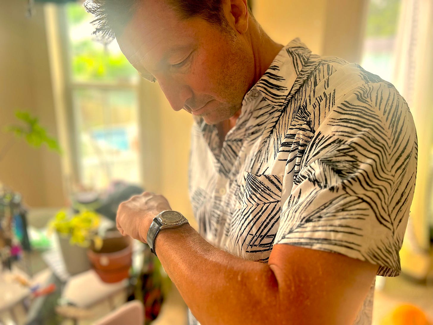 Gentry Bronson looks down at his magic watch worn on his wrist