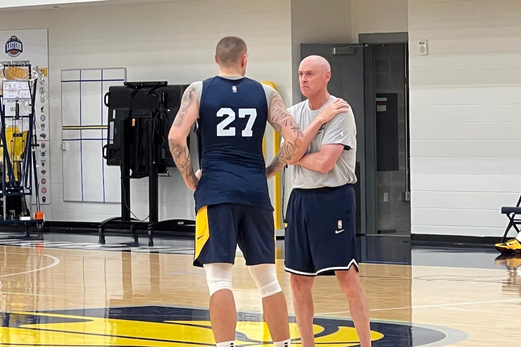 Daniel Theis talks with Pacers head coach Rick Carlisle after practice.