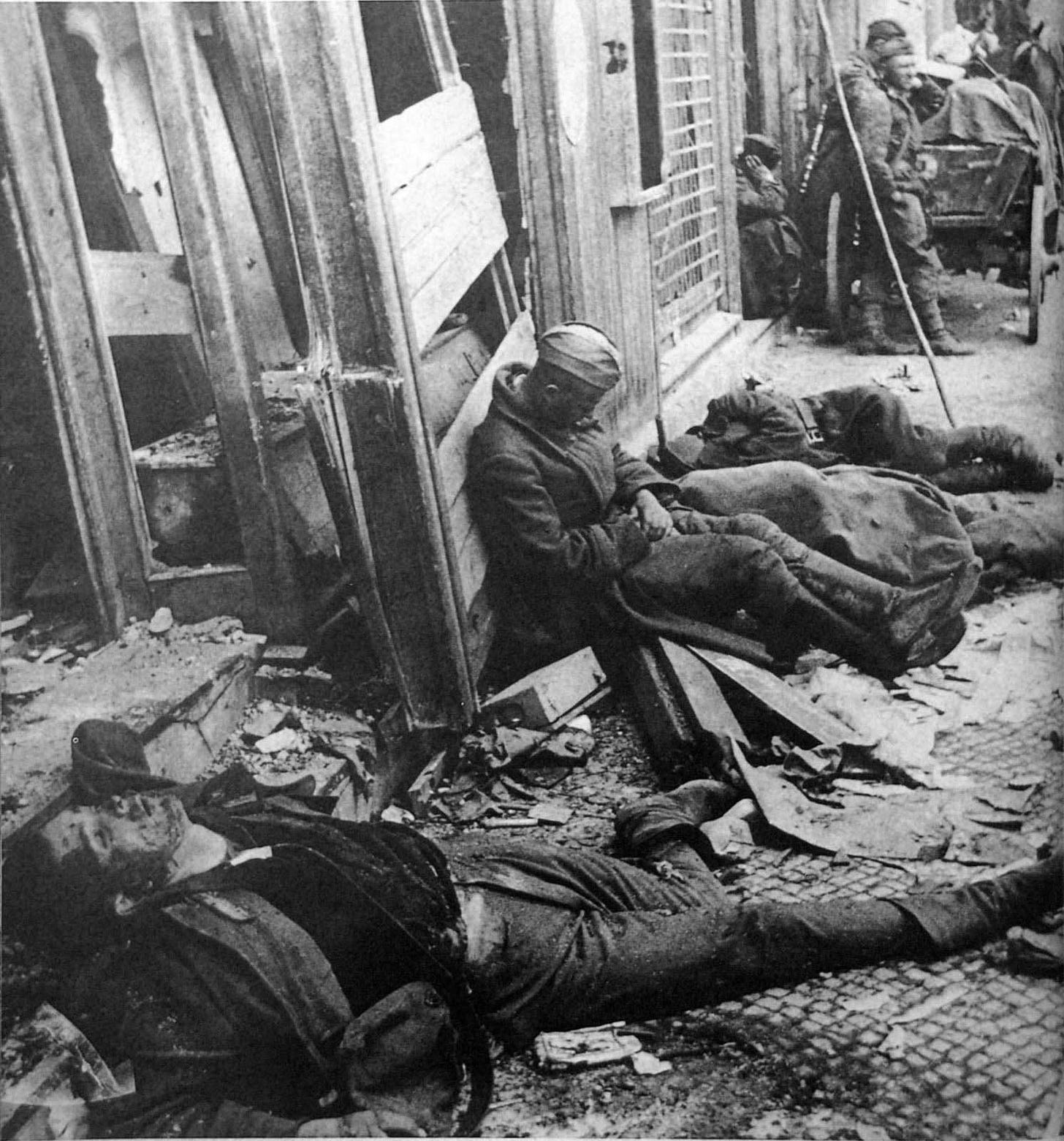 A Soviet soldier pauses next to a fallen German soldier after the brutal Battle of Berlin, May 1945.