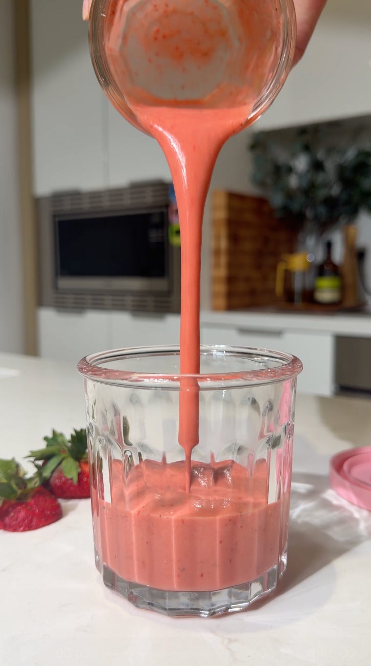 Strawberry white balsamic salad dressing being poured into a glass jar