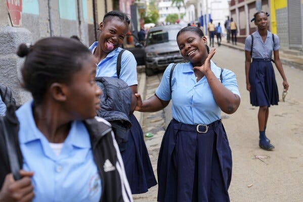 Students strike poses at the end of their school day, in Cap-Haitien, Haiti, Wednesday, April 17, 2024. (AP Photo/Ramon Espinosa) Students strike poses at the end of their school day, in Cap-Haitien, Haiti, Wednesday, April 17, 2024. (AP Photo/Ramon Espinosa)