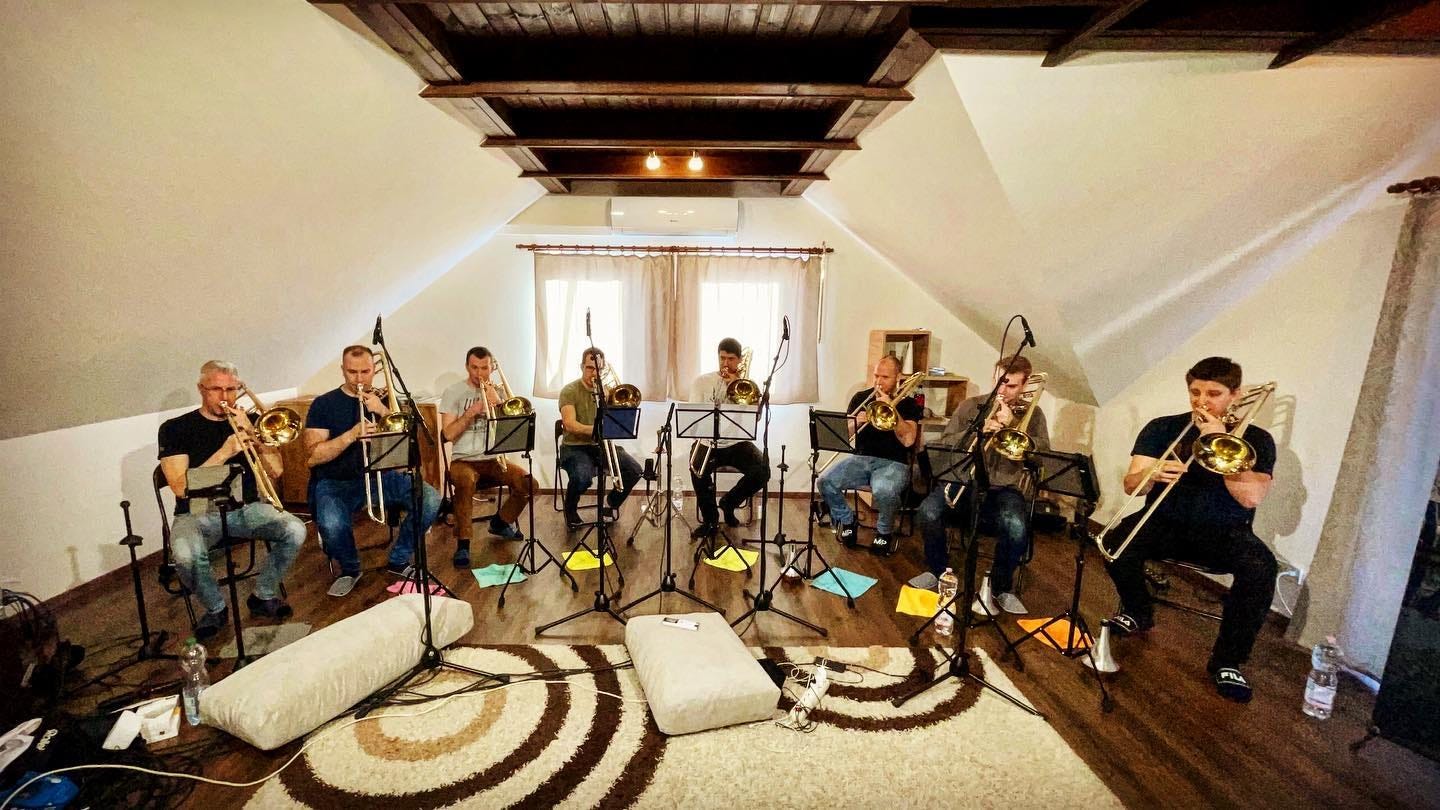 May be an image of 8 people, people playing musical instruments, people sitting, guitar and indoor