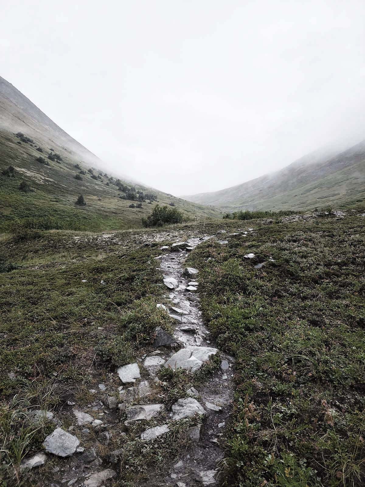 A rocky path in foggy mountains. 