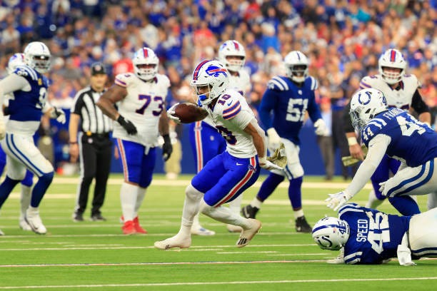 Khalil Shakir of the Buffalo Bills carries the ball past Zaire Franklin and E.J. Speed of the Indianapolis Colts during the fourth quarter at Lucas...