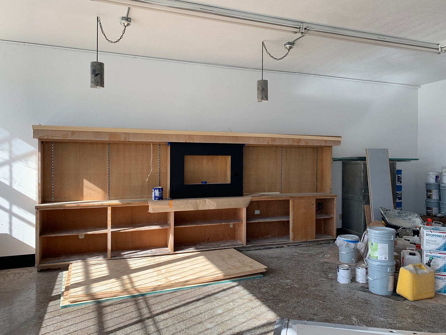 sun filled vacant retail space with construction materials strewn about sun filled vacant retail space with construction materials strewn about