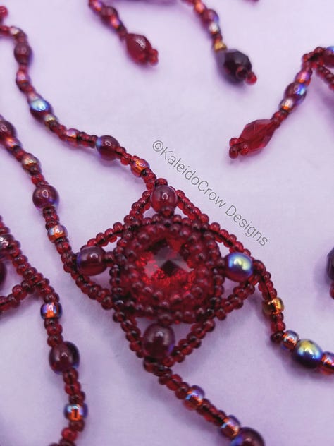 Closeups of a deep red beaded necklace with glass beads