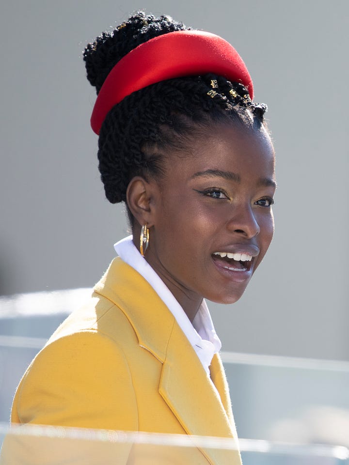Left tan puddle of a heart, right Amanda Gorman in a yellow jacket and a red had on her head.
