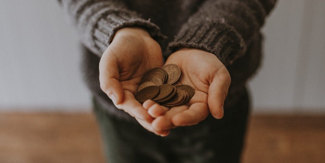 copper-colored coins on in person's hands