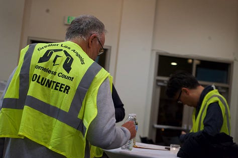 A person in a shared environment, photographed from a distance to preserve anonymity and atmosphere.