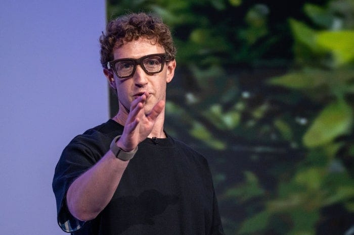 Mark Zuckerberg wearing Meta Ray-Ban smart glasses and gesturing at a conference. Mark Zuckerberg wearing Meta Ray-Ban smart glasses and gesturing at a conference.
