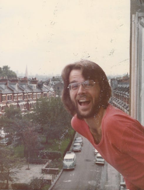 Gregg poking his head out his flat window with its “spectacular view” of the Belsize Park neighbourhood—and beyond.