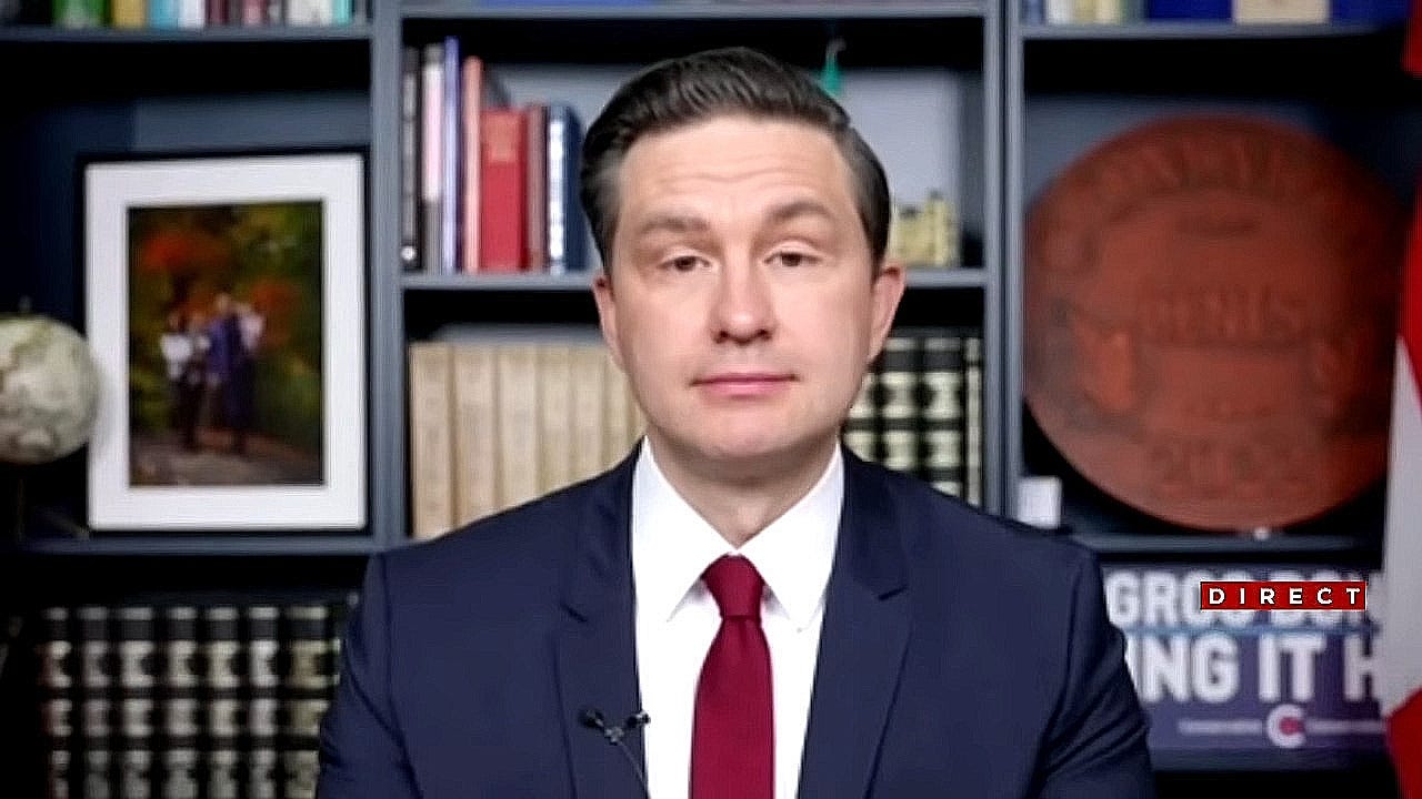 Pierre Poilievre sits in front of a bookshelf and looks ahead. Television broadcast still. Pierre Poilievre sits in front of a bookshelf and looks ahead. Television broadcast still.