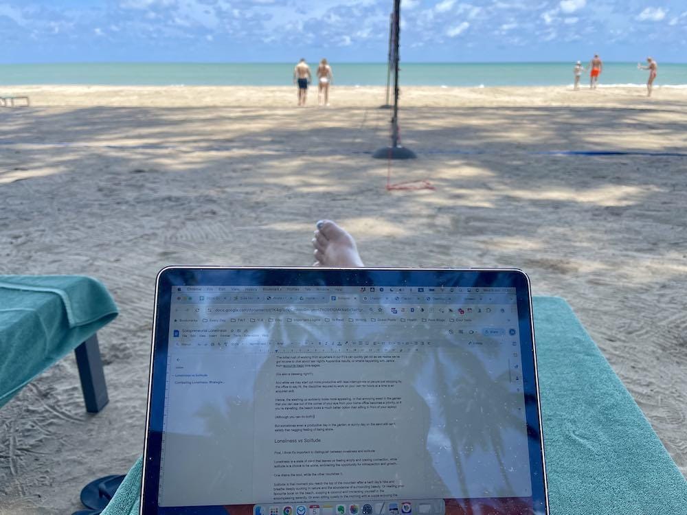 sitting and laptop on my lap in front of the beach