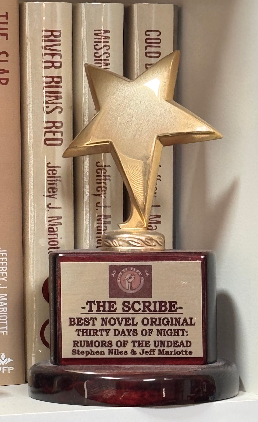 A star-shaped trophy in front of some books
