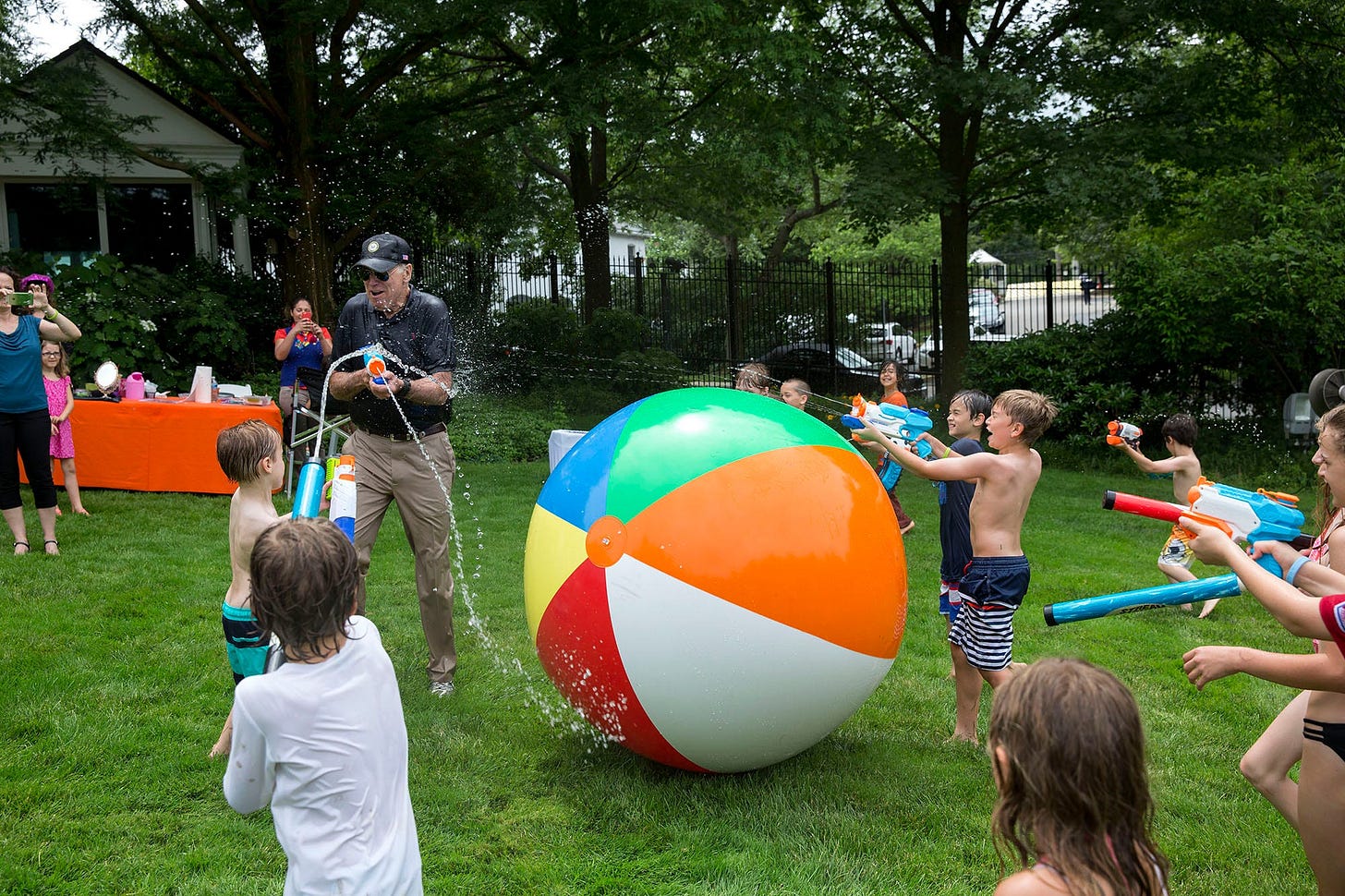 June 4, 2016: Vice President Joe Biden playfully chases children and press members with a super soaker during the lively 2016 Biden Beach Boardwalk Bash at the Naval Observatory Residence. June 4, 2016: Vice President Joe Biden playfully chases children and press members with a super soaker during the lively 2016 Biden Beach Boardwalk Bash at the Naval Observatory Residence.