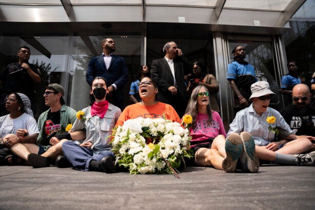 Protesters sit-in and block the entrance to Citi's office in Manhattan during the Migrant and Displaced Peoples Week Protesters sit-in and block the entrance to Citi's office in Manhattan during the Migrant and Displaced Peoples Week