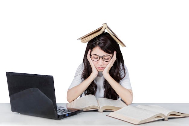 Bored female student reading books in the studio | Premium Photo Bored female student reading books in the studio | Premium Photo