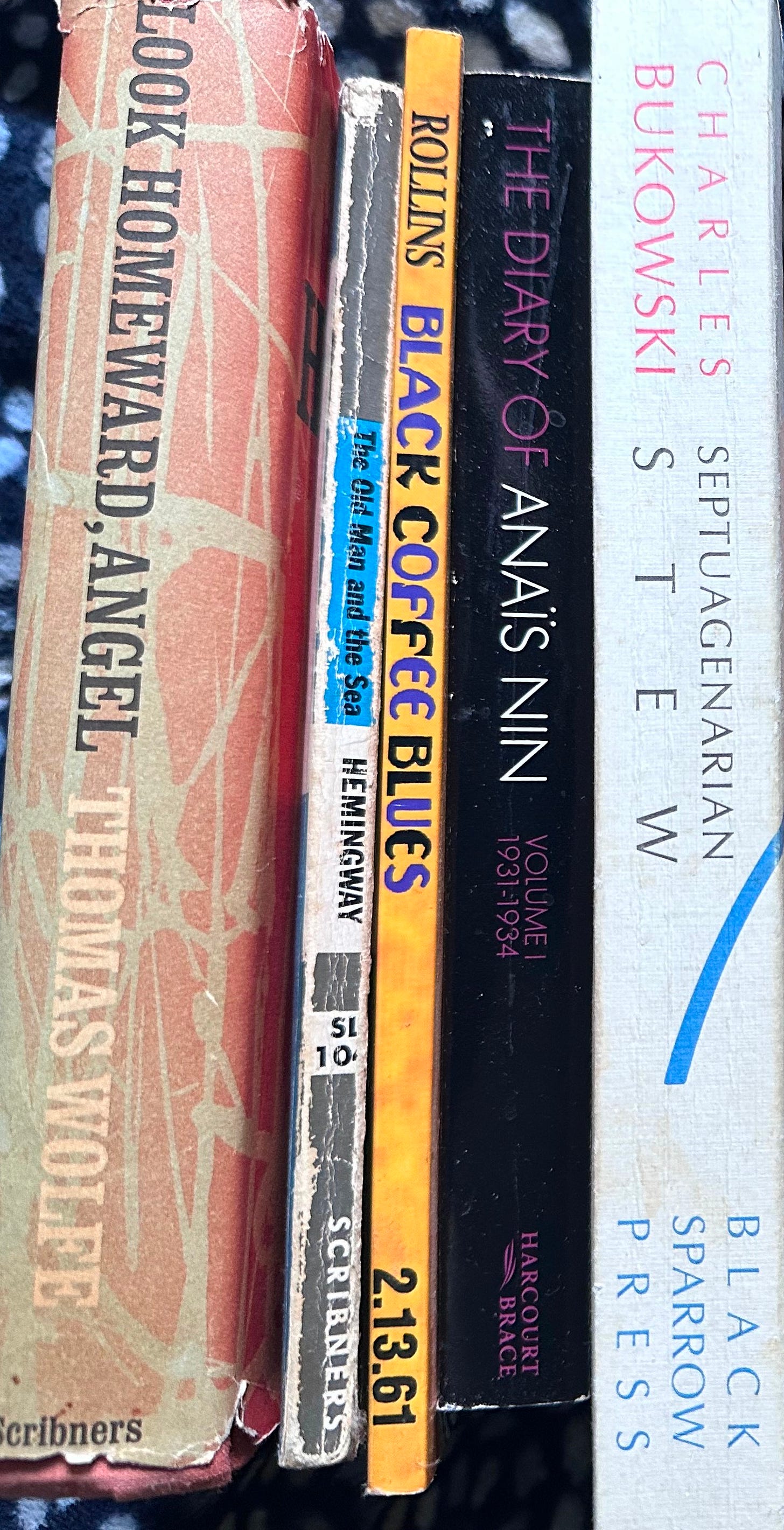 STACK OF THE AUTHORS BOOKS THAT INFLUENCED HIS WRITING. NOT AT ALL A COMPLETE LIST.  BUKOWSKI,NIN,HEMINGWAY,ROLLINS, WOLFE. NO JOHN MICHAEL GREER, OR HENRY MILLER, OR NABAKOV. ONLY SO MUCH ROOM. NO FLANNERY O'CONNER, NO JIM THOMPSON, NO NAOMI KLEIN, THE LIST GOES ON.
