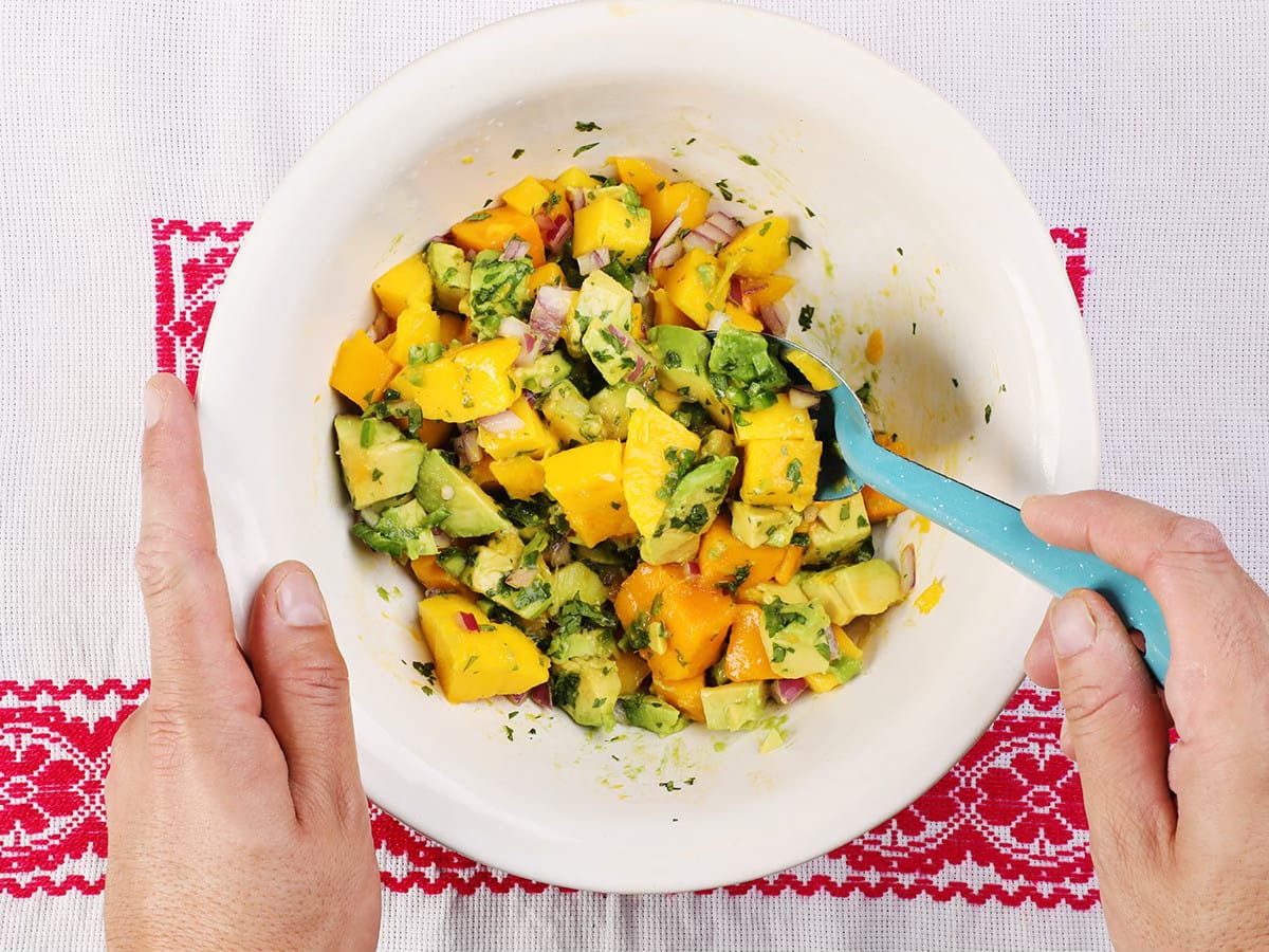 stirring mango avocado salsa