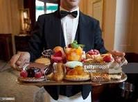 Waiter Displaying French Desserts On Tray High-Res Stock ...