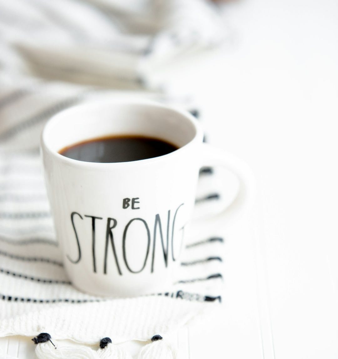 white ceramic mug filled with black coffee