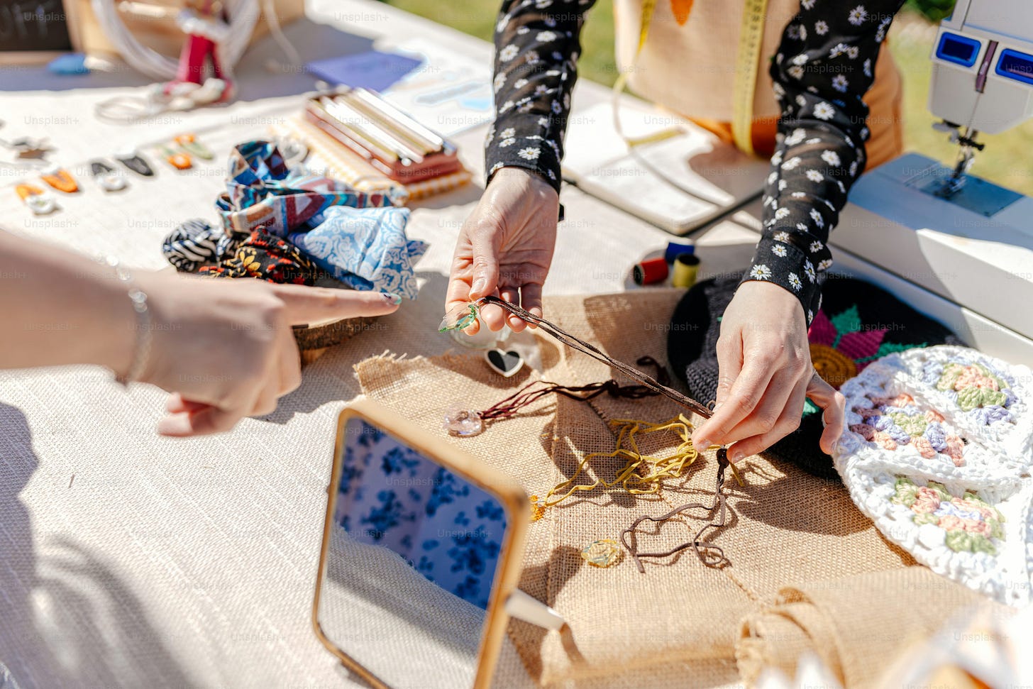 a woman is working on a piece of fabric