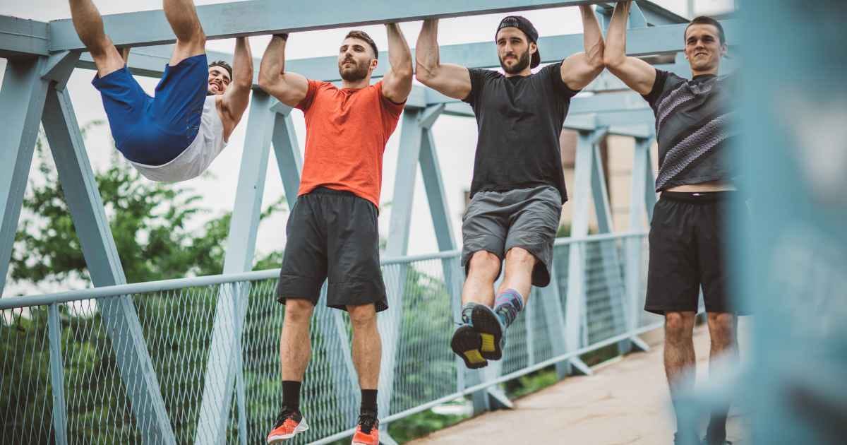 four guys on a bridge doing pullups 