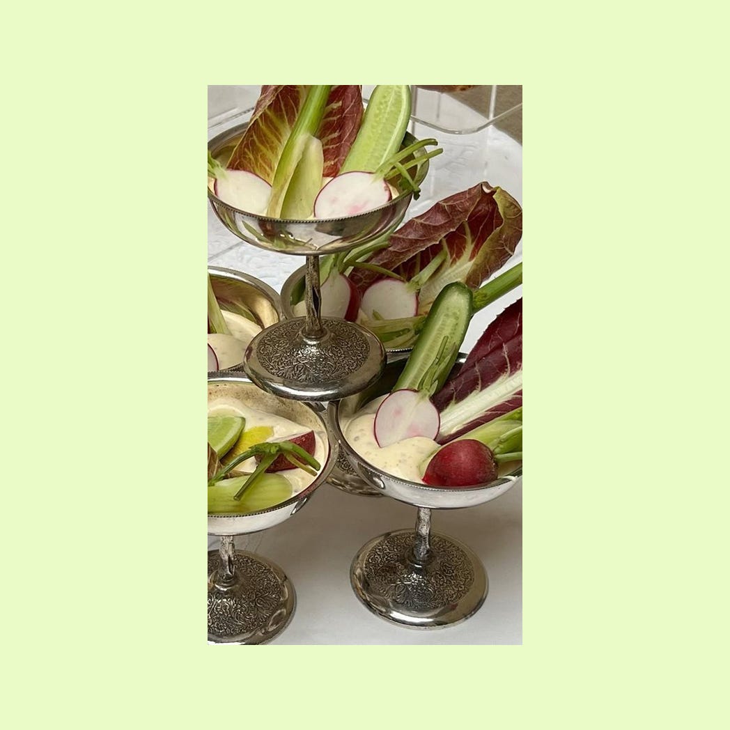 A coupe tower, with each coupe holding a small vegetable crudités spread.