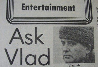 Man wearing a fur hat with the words Ask Vlad to the left.