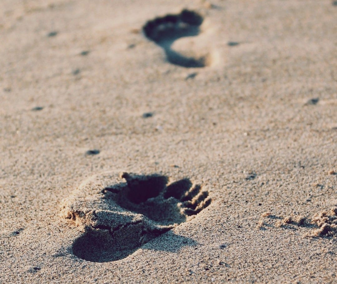 foot prints on beach sand