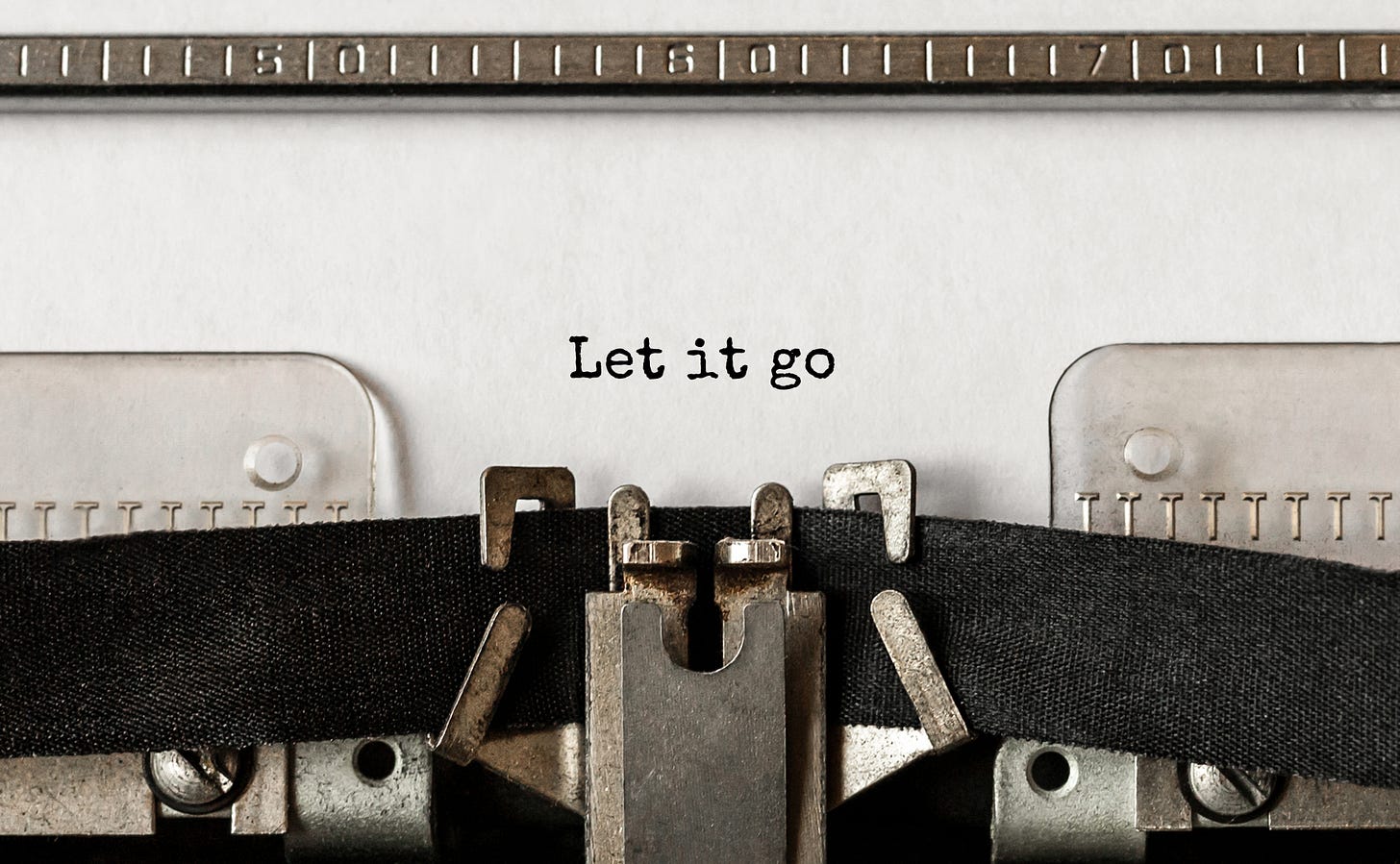 An image of an old typing maching with "Let it go" printed on white paper.