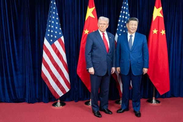 Donald Trump and Xi Jinping standing next to each other in front of U.S. and Chinese flags.