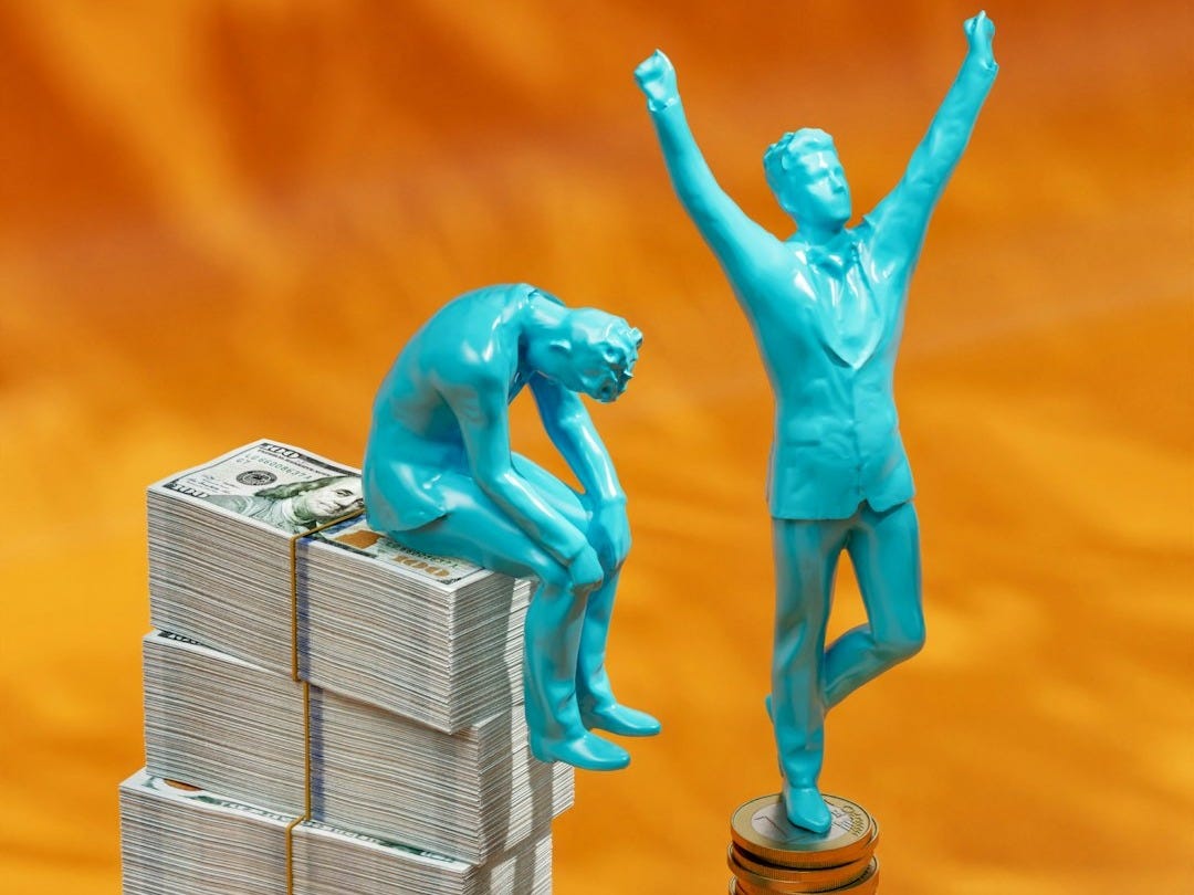 a statue of a man standing on top of stacks of money a statue of a man standing on top of stacks of money