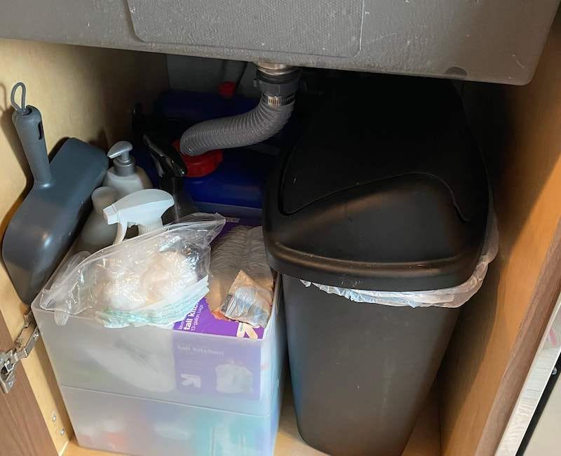 The under-sink area of our converted camper van