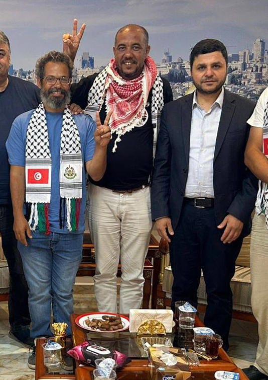 Grinning as he gives a Churchillian 'victory' sign, Wael Nawar, the spokesman for Greta Thunberg's Gaza 'freedom flotilla' poses with Youssef Hamdan, who runs Hamas' North African operation, during a meeting at its Algerian headquarters in June Grinning as he gives a Churchillian 'victory' sign, Wael Nawar, the spokesman for Greta Thunberg's Gaza 'freedom flotilla' poses with Youssef Hamdan, who runs Hamas' North African operation, during a meeting at its Algerian headquarters in June