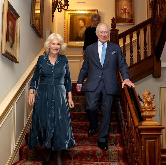 Queen Camilla and King Charles smiling walking downstairs in Clarence House Queen Camilla and King Charles smiling walking downstairs in Clarence House