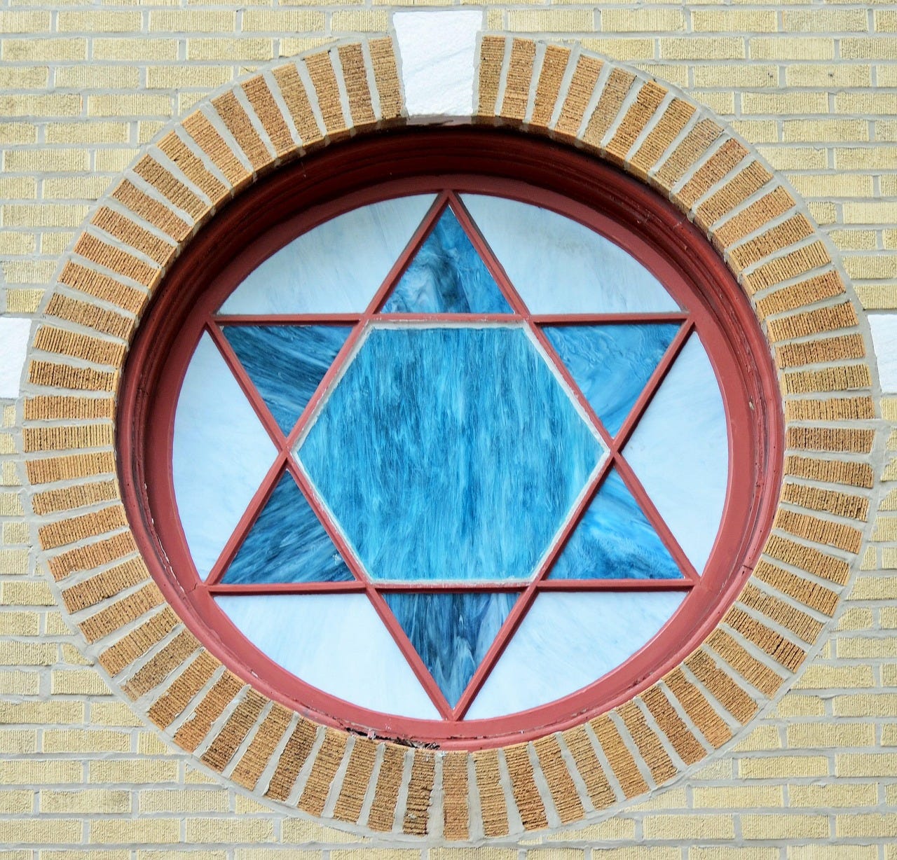  a window with a blue stained glass star of david