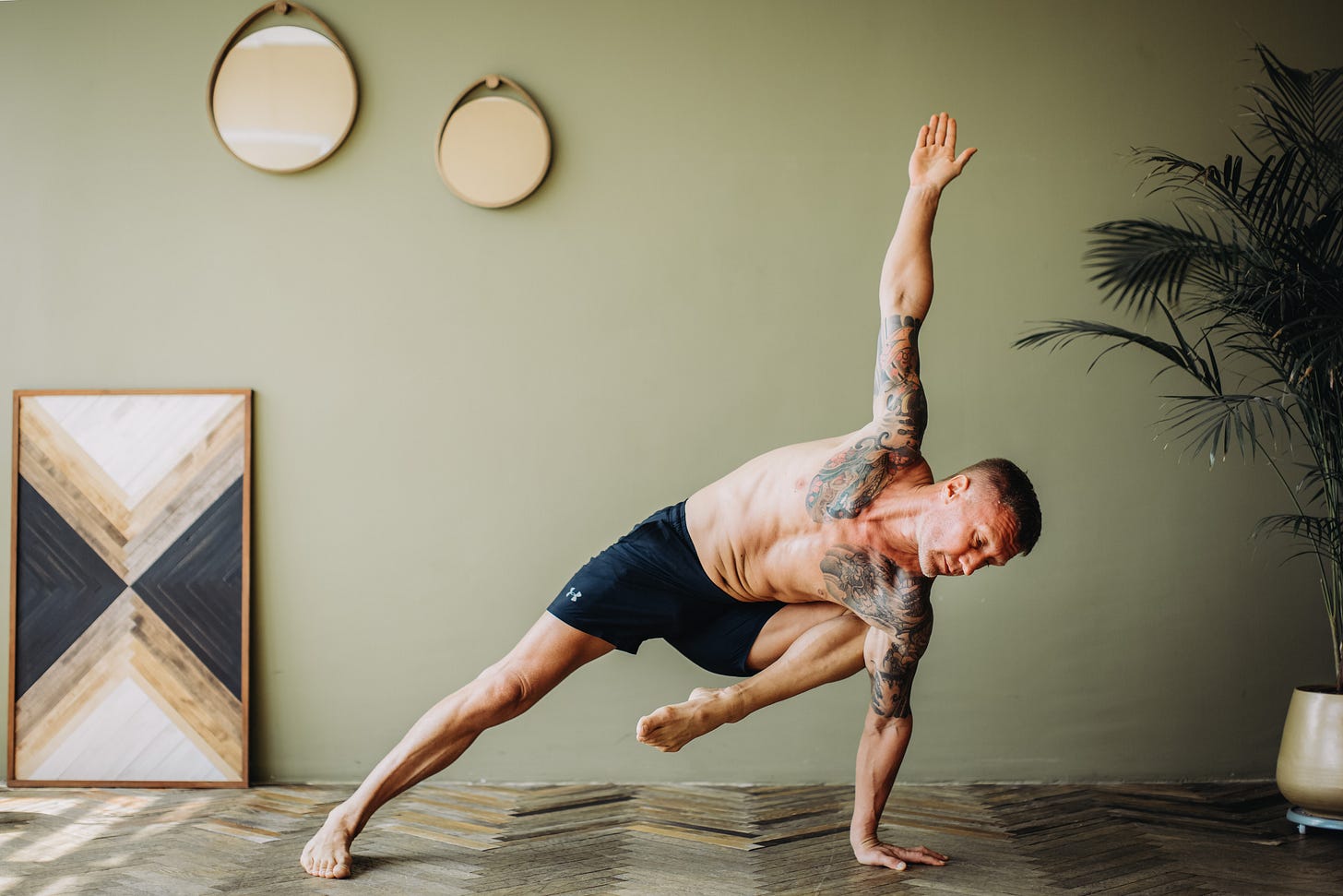 man doing a yoga pose on the floor man doing a yoga pose on the floor