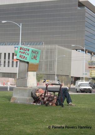 A homeless man sleeps in the shadow of corporate America. A homeless man sleeps in the shadow of corporate America.