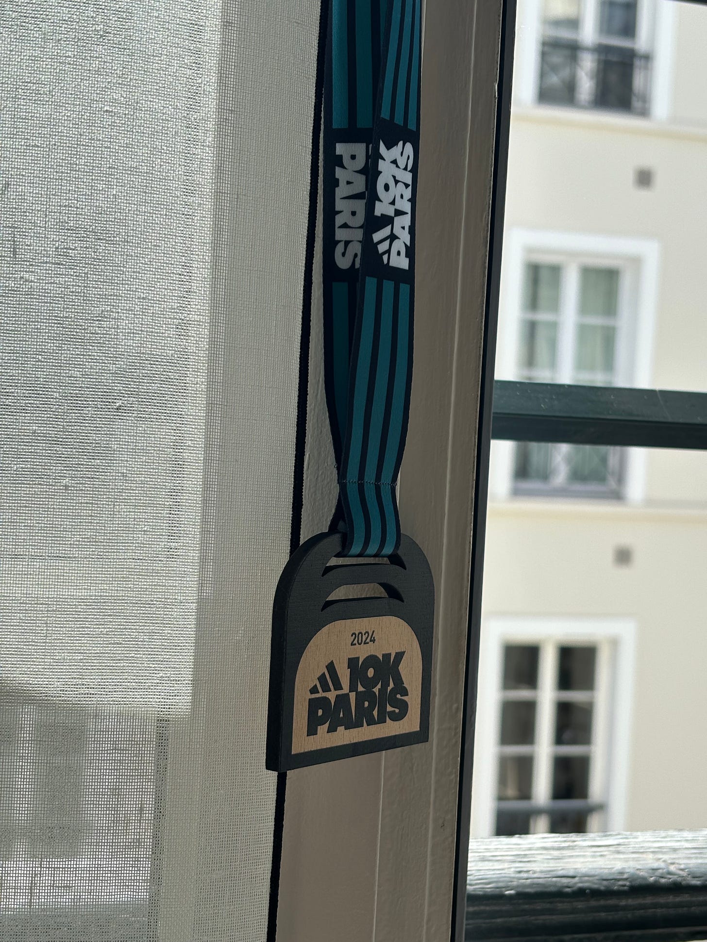 Runners at the 2024 Adidas 10K Paris received a wooden medal