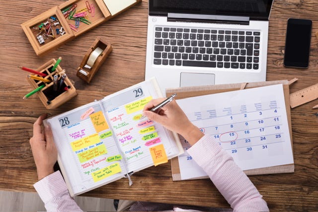 Image of a desk with a calendar and diary open