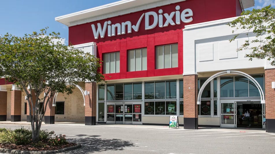 A picture of a Winn Dixie store front with white lettering and red accents and background