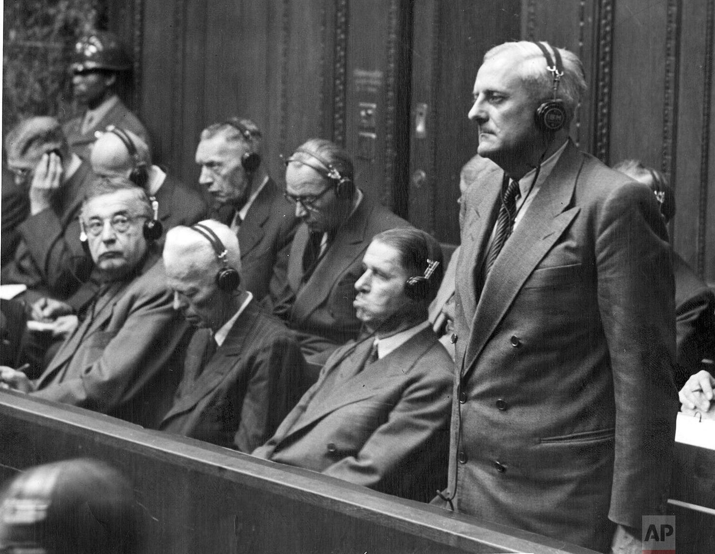 Otto Ambros, chief of the chemical warfare Committee, stands as he hears his eight-year prison verdict from the U.S. Military Tribunal in Nuremberg on July 30, 1948.