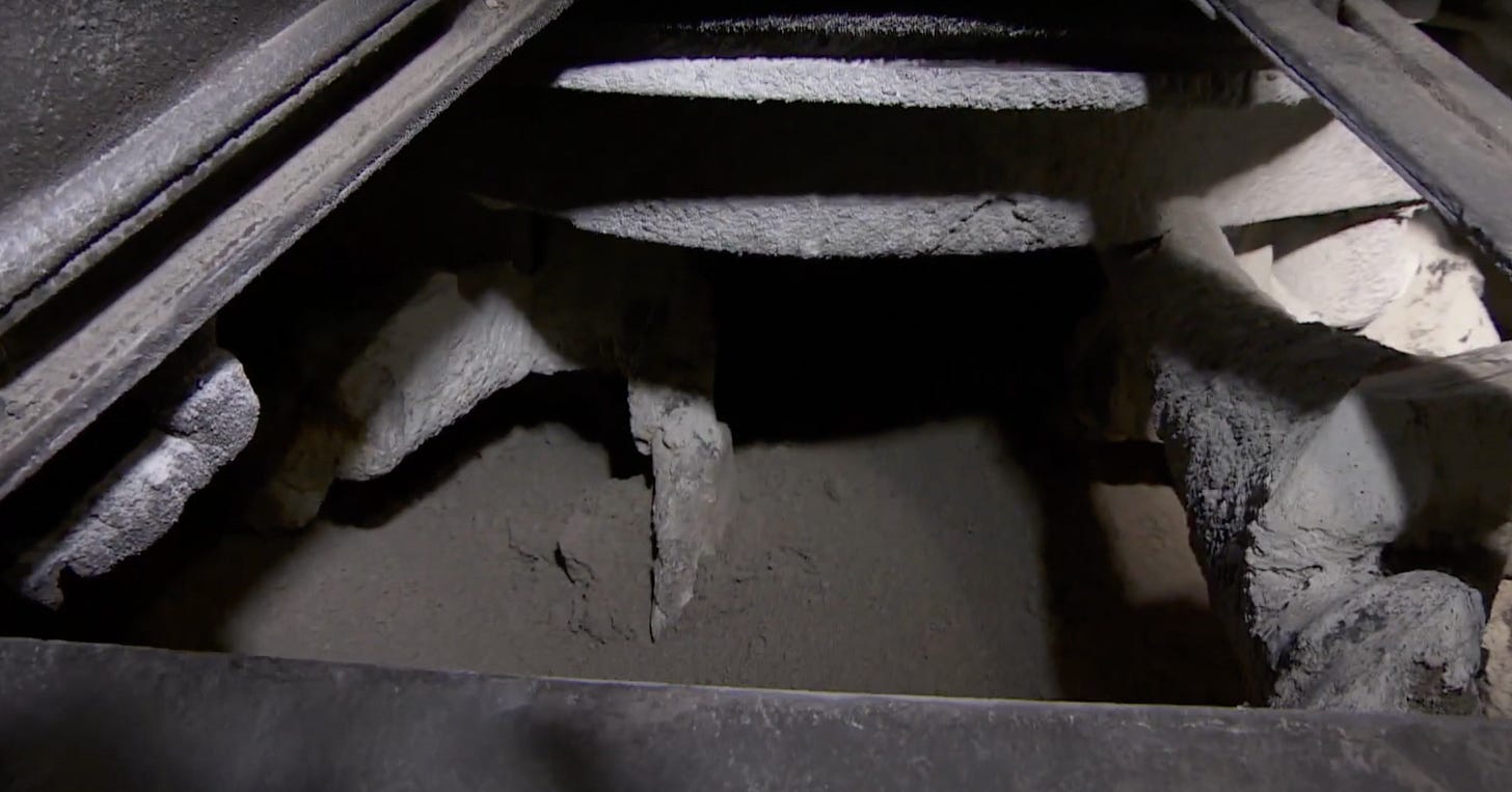 Concrete-covered metal inside a wet concrete mixer Concrete-covered metal inside a wet concrete mixer