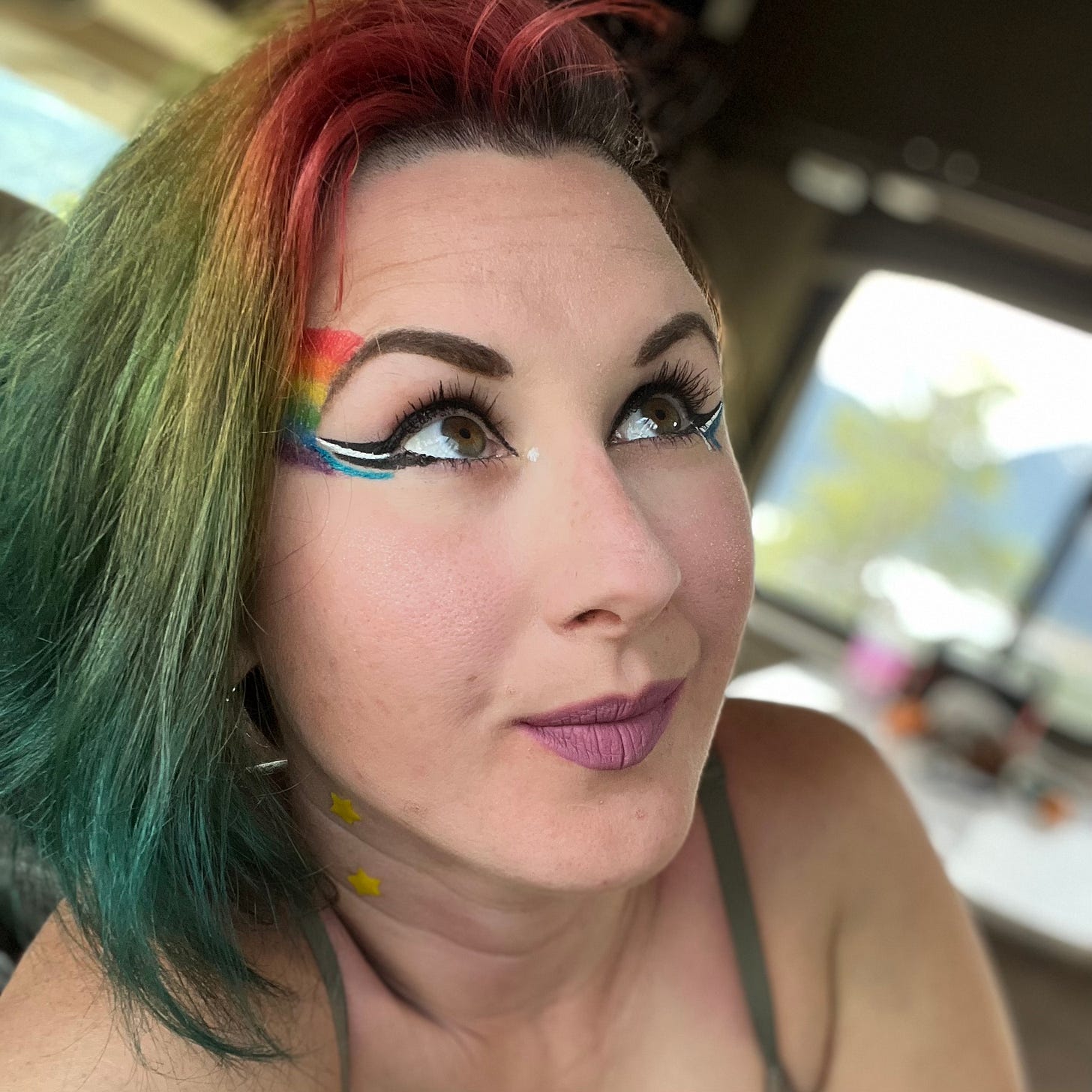 Lyric Rivera, when they had rainbow hair, with matching rainbow eye makeup and black and white bold, winged eyeliner. Lyric Rivera, when they had rainbow hair, with matching rainbow eye makeup and black and white bold, winged eyeliner.