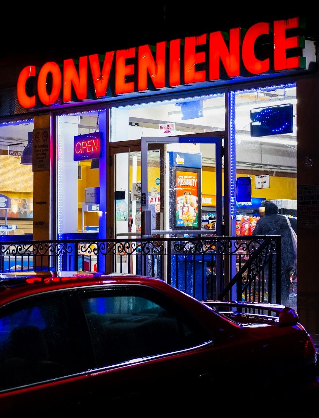 A brightly lit convenience store at night A brightly lit convenience store at night