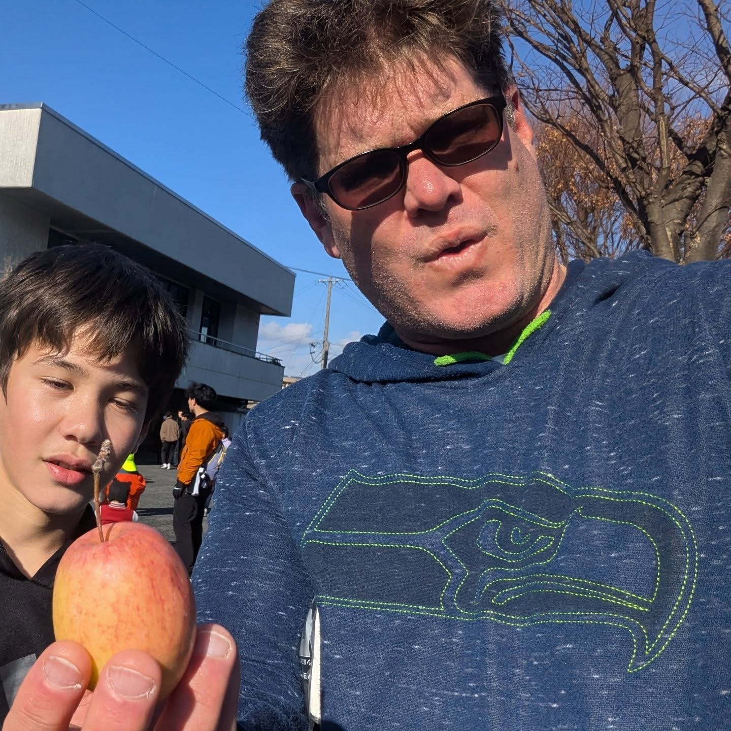 May be an image of 2 people and apple