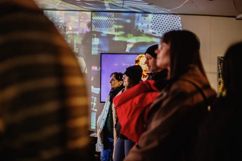 Images of artists working with computers and projectors in an art gallery